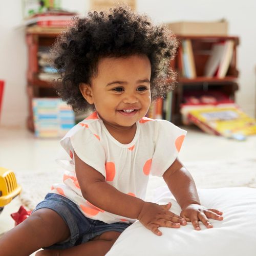 happy-baby-girl-playing-with-toys-playroom.jpg
